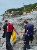 Two research scientists equipped with GPS research tools