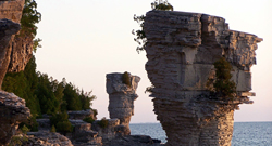 Natural stone pillars along a shoreline