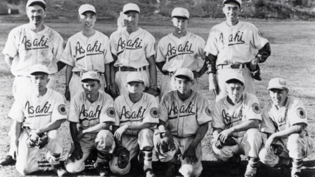 Black and white photo of a baseball team with Asahi written on each person's shirt