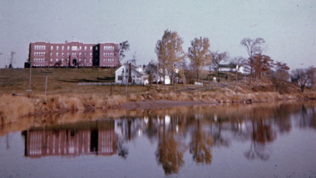 A large building on the side of water