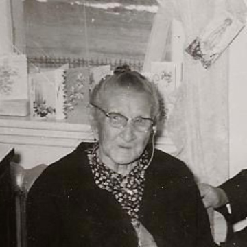 Black and white portrait of a women seated on a chair