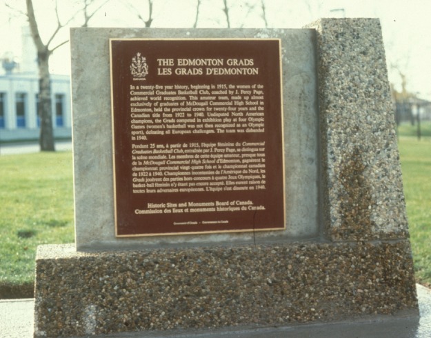 A commemorative bronze plaque on a stone stand