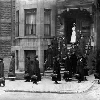 Black and white photo of a group of women in front of a building