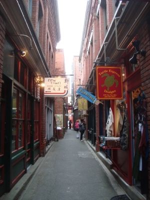 Alley with brick walls and posters of shops