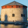 A circular tower beside the water