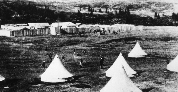 Image of Fort Walsh with tents sent up in foreground