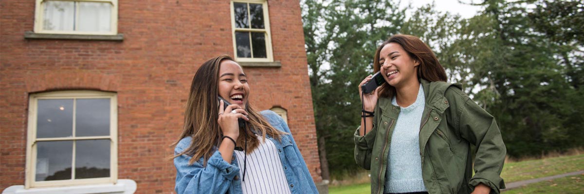 Two visitors listening to audio tour devices.