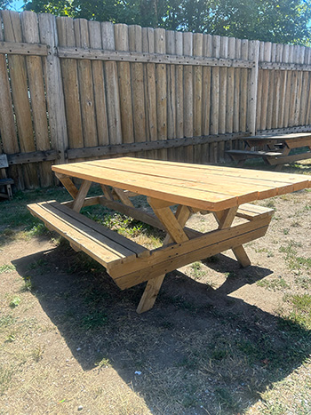 A picnic table with extended top for wheelchair access.