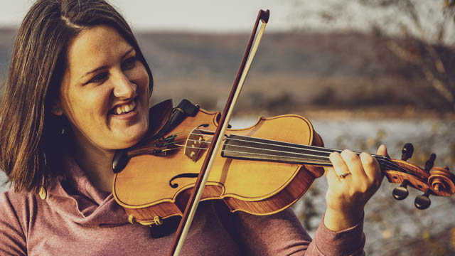A woman with a fiddle.