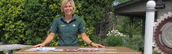A Parks Canada employee standing at a table.