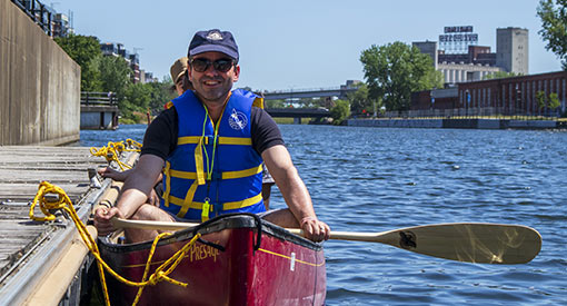 Smiling man in a canoe on the Lachine Canal