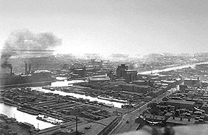 Photography showing the canal, two basins, some factories, and the South-West of Montréal