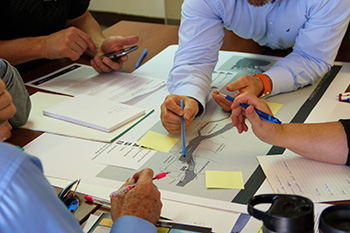 close up on people hands filling documents