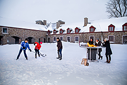 A field hockey competition in the courtyard of Fort Chambly in winter