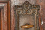 Knob on the door leading to the carriage entrance, at ground floor.