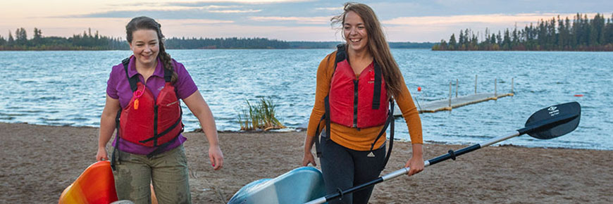 Two  paddlers wear approved life jackets