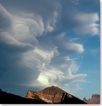 A chinook arch cloud over a mountain peak in Waterton