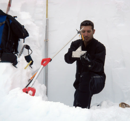 Ali Haeri determines snow density using a modern weighing scale, 2012