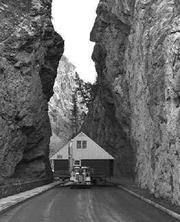 Transport truck hauling a house through Sinclair Canyon