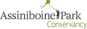 One line of black text says Assiniboine Park with a black silhouette of a child playing with a green kite in between the words. A line of green text below says Conservancy.