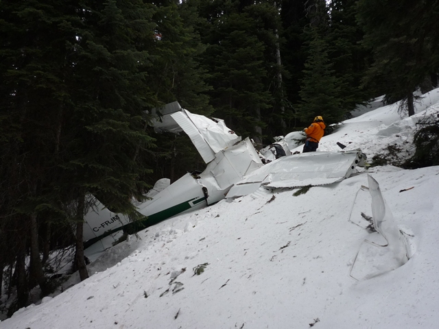 A Parks Canada Visitor Safety Specialist at work on the site of the airplane crash