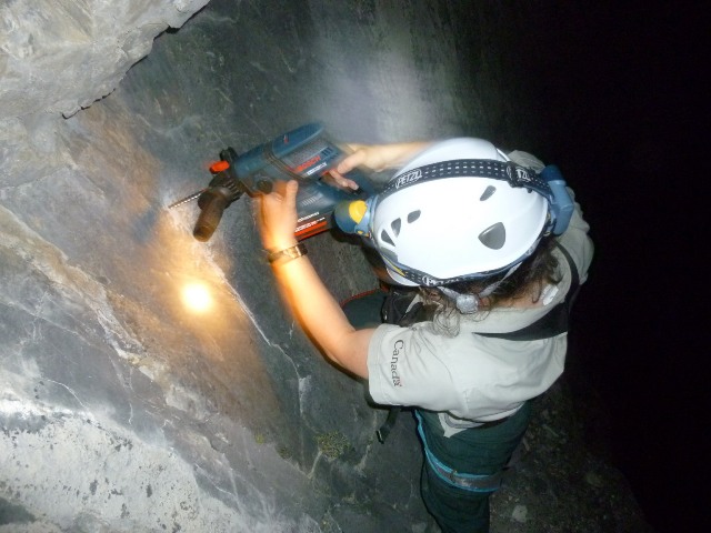 A Safety drills a bolt anchor in order to safely rescue the stranded scramblers. 
