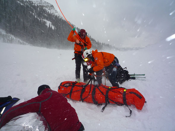 Mountain Safety Specialists prepare an accident victim for helicopter transport to the hospital. 