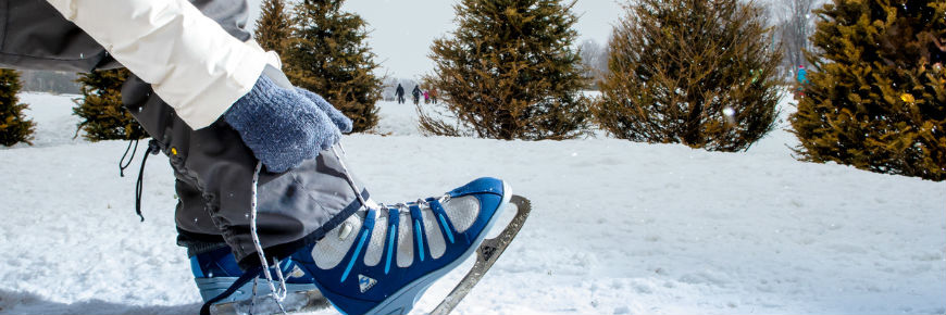 A person lacing up her ice skates