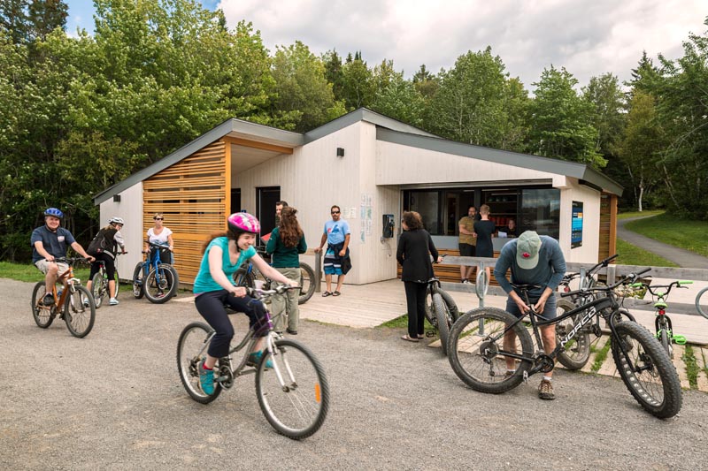 Visitors on bikes in front of the Ryans Rentals Centre.