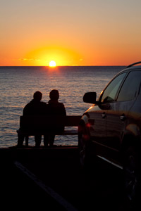 Two visitors enjoy a sunrise at Black Brook Beach