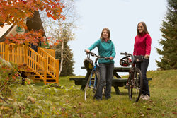Two women and bikes beside an oTENTik
