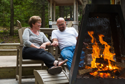 A couple relaxing by a campfire