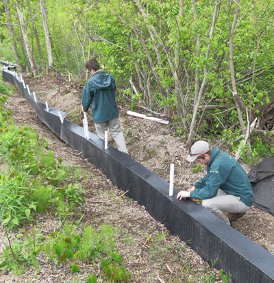 Park staff install specialized fencing