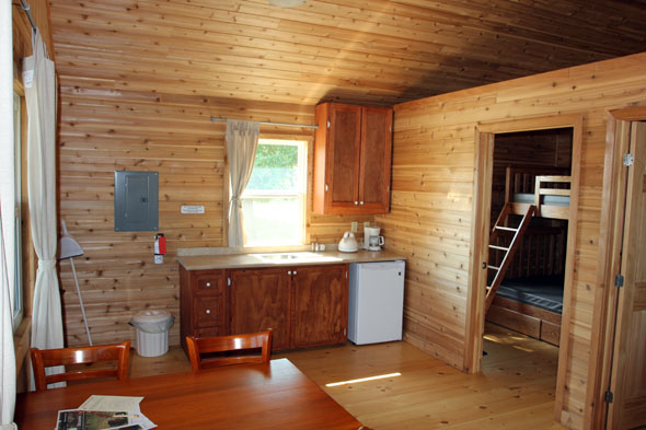 the kitchen inside the cabin including a sink and fridge