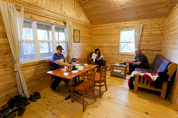 a famly enjoys supper inside a cabin