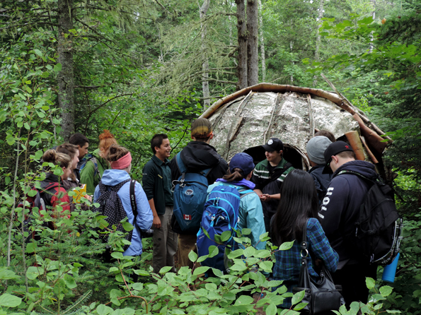 Parks Canada interpreter explaining the birch bark dome wigwam