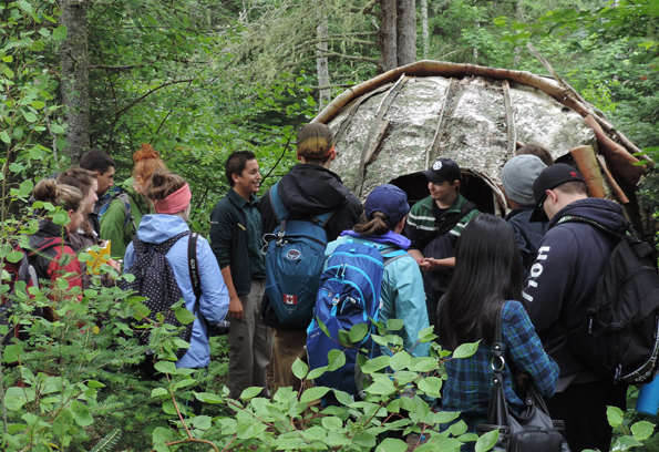 Parks Canada interpreter explaining the birch bark dome wigwam