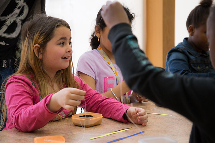 Children around a table taking part in an educational activity.