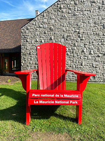 A red chair in front of a brick wall