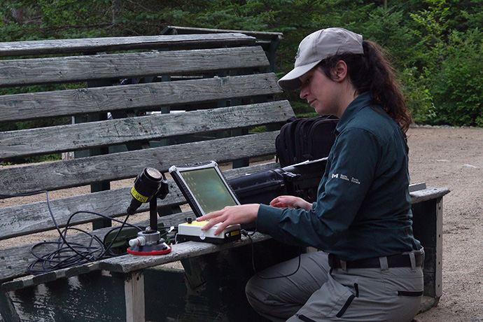 A Parks Canada employee sets up equipment for bat survey.