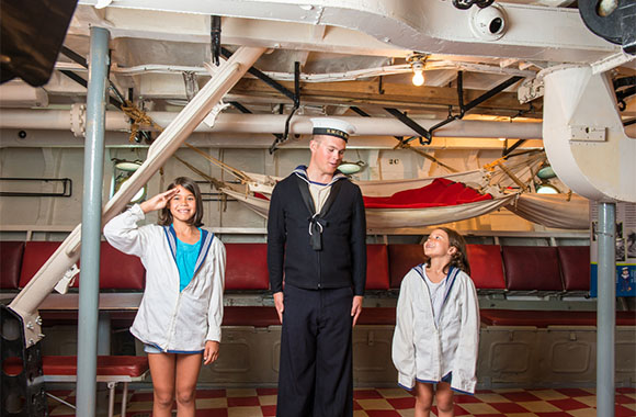 Young visitors dressed up as new recruits in the Mess Deck