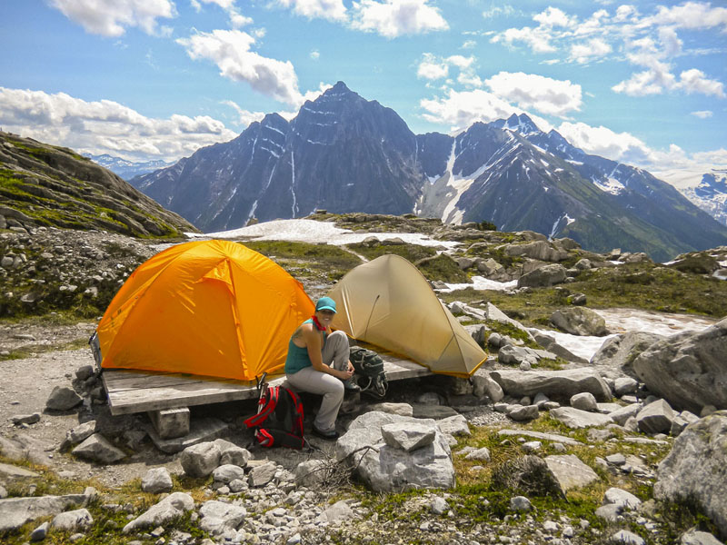 A woman camping in Hermit Meadows area, a mountainous landscape.