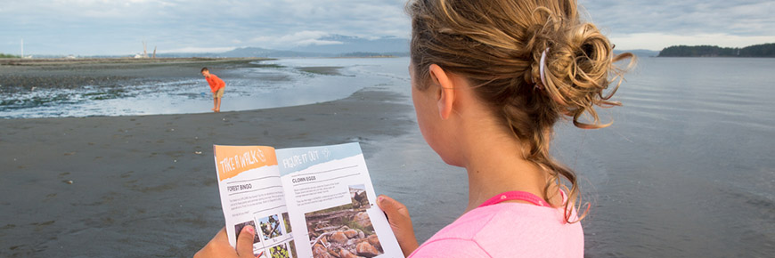 On Sidney Spit, two kids explore shallow water lapping at the shore